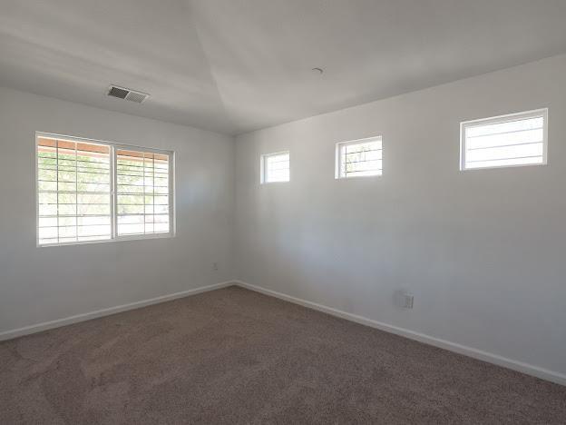 435 E San Pedro St, Merced, CA 95341 - carpeted spare room featuring baseboards