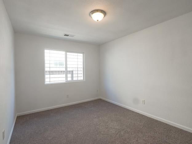 435 E San Pedro St, Merced, CA 95341 - carpeted spare room featuring baseboards