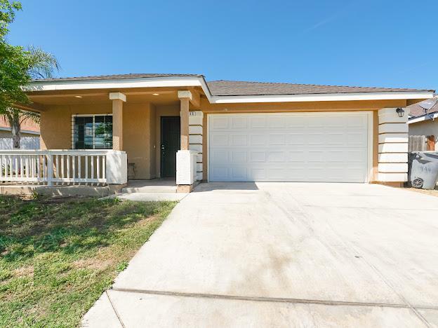 435 E San Pedro St, Merced, CA 95341 - single story home with a garage, driveway, stucco siding, and covered porch