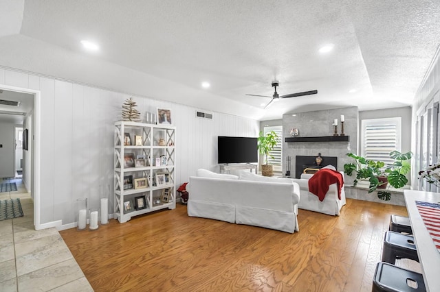 6658 N Thorne Ave, Fresno, CA 93711 - living room featuring ceiling fan, healthy amount of natural light, a textured ceiling, a large fireplace, and recessed lighting
