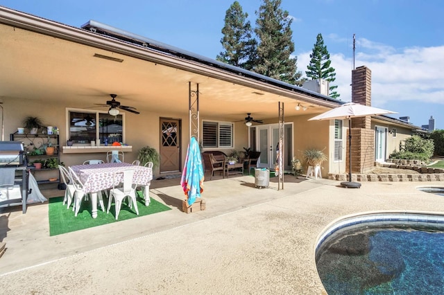 6658 N Thorne Ave, Fresno, CA 93711 - rear view of property featuring a ceiling fan, outdoor dining space, a patio, stucco siding, and a chimney