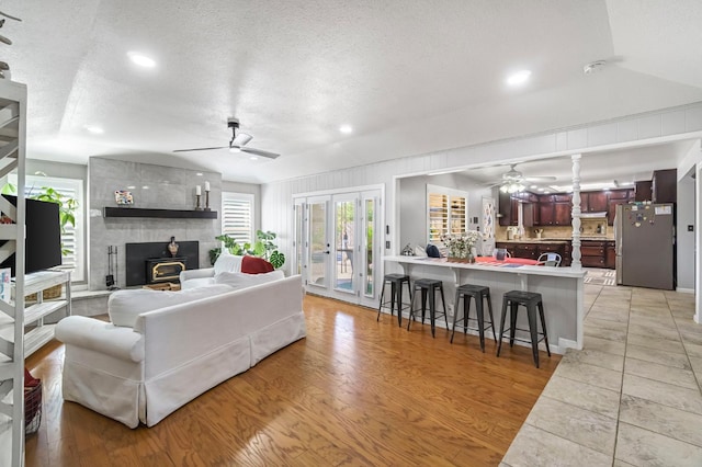 6658 N Thorne Ave, Fresno, CA 93711 - living area featuring ceiling fan, a textured ceiling, a wood stove, french doors, and recessed lighting