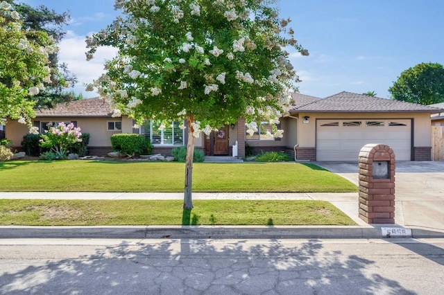 6658 N Thorne Ave, Fresno, CA 93711 - view of front of house featuring concrete driveway, an attached garage, a front lawn, brick siding, and stucco siding