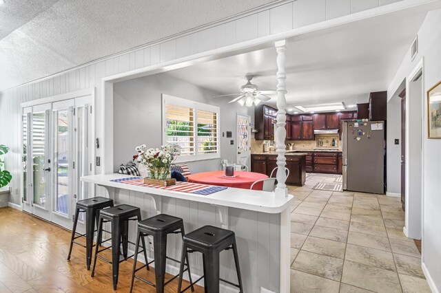 6658 N Thorne Ave, Fresno, CA 93711 - kitchen featuring freestanding refrigerator, light countertops, healthy amount of natural light, ceiling fan, and a textured ceiling