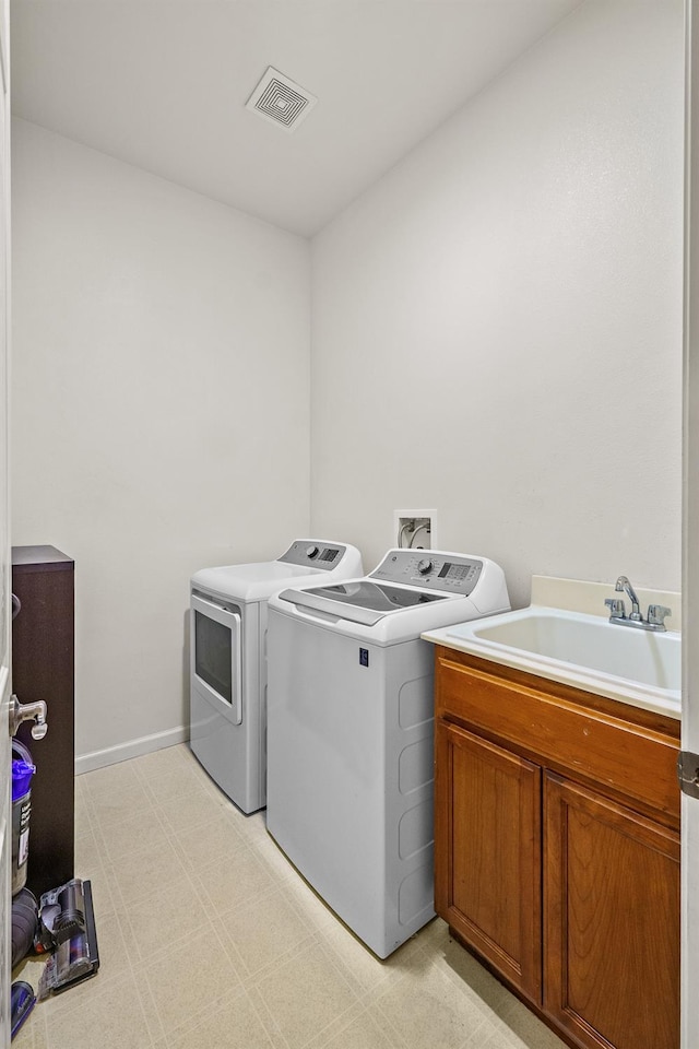 2403 W Robin Ave, Visalia, CA 93291 - laundry area featuring washer and dryer, cabinet space, and light floors