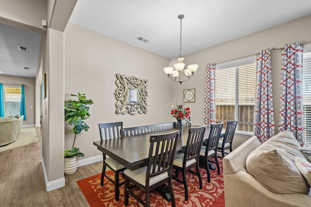 2403 W Robin Ave, Visalia, CA 93291 - dining room featuring a chandelier, wood finished floors, and healthy amount of natural light