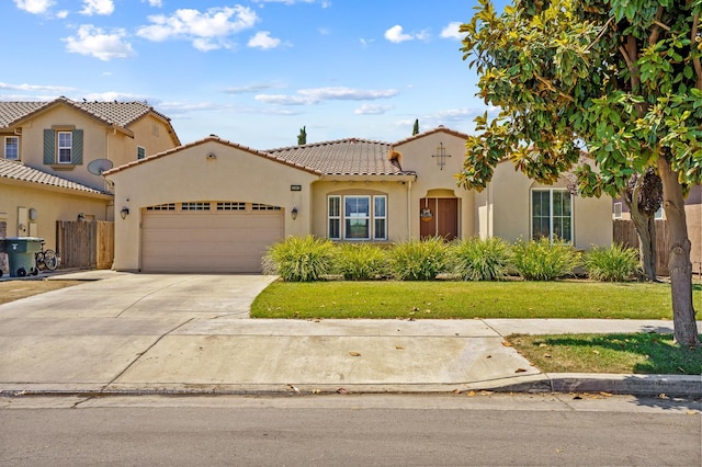 2403 W Robin Ave, Visalia, CA 93291 - mediterranean / spanish house featuring a tile roof, an attached garage, stucco siding, and concrete driveway