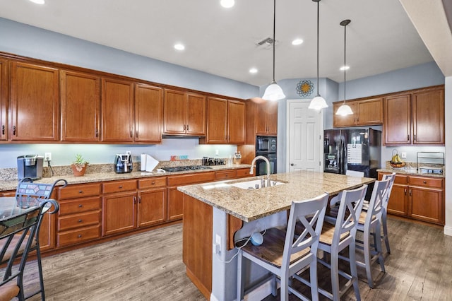 2403 W Robin Ave, Visalia, CA 93291 - kitchen featuring black appliances, brown cabinets, and recessed lighting