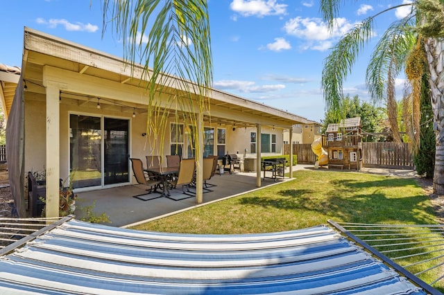 2403 W Robin Ave, Visalia, CA 93291 - back of property featuring a playground, stucco siding, and a patio
