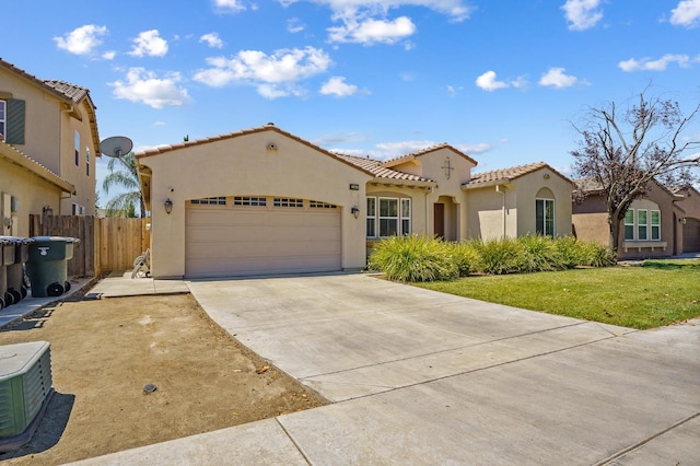 2403 W Robin Ave, Visalia, CA 93291 - mediterranean / spanish home with stucco siding, a tile roof, a garage, and concrete driveway