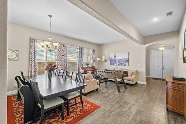 2403 W Robin Ave, Visalia, CA 93291 - dining room featuring arched walkways, a chandelier, and light wood-style flooring
