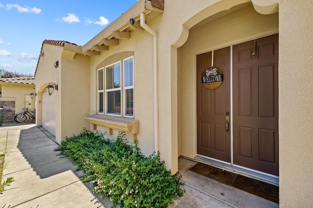 2403 W Robin Ave, Visalia, CA 93291 - view of exterior entry with stucco siding and an attached garage