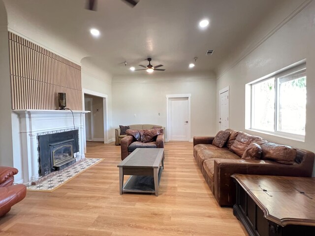 7013 N Maroa Ave, Pinedale, CA 93650 - living room featuring ceiling fan, light wood-type flooring, recessed lighting, a fireplace with flush hearth, and crown molding