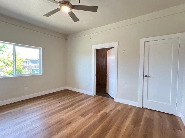 7013 N Maroa Ave, Pinedale, CA 93650 - unfurnished bedroom with wood finished floors and a ceiling fan
