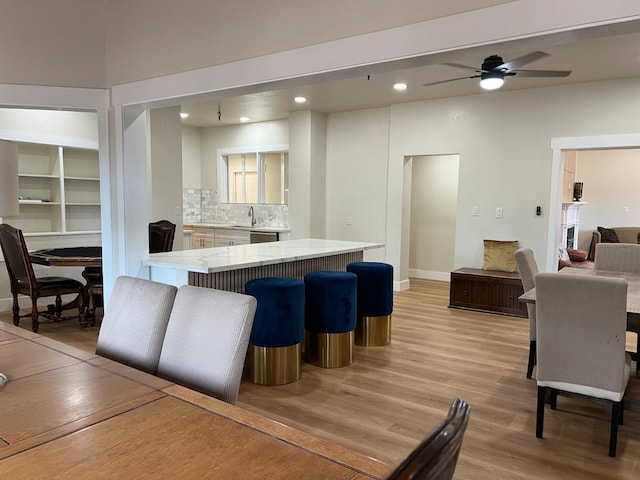 7013 N Maroa Ave, Pinedale, CA 93650 - kitchen with light wood-style flooring, open floor plan, light countertops, backsplash, and recessed lighting