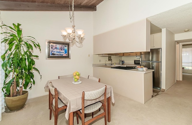6338 N Maroa Ave Unit 115, Fresno, CA 93704 - dining room featuring light colored carpet, a chandelier, and a wood ceiling with exposed beams