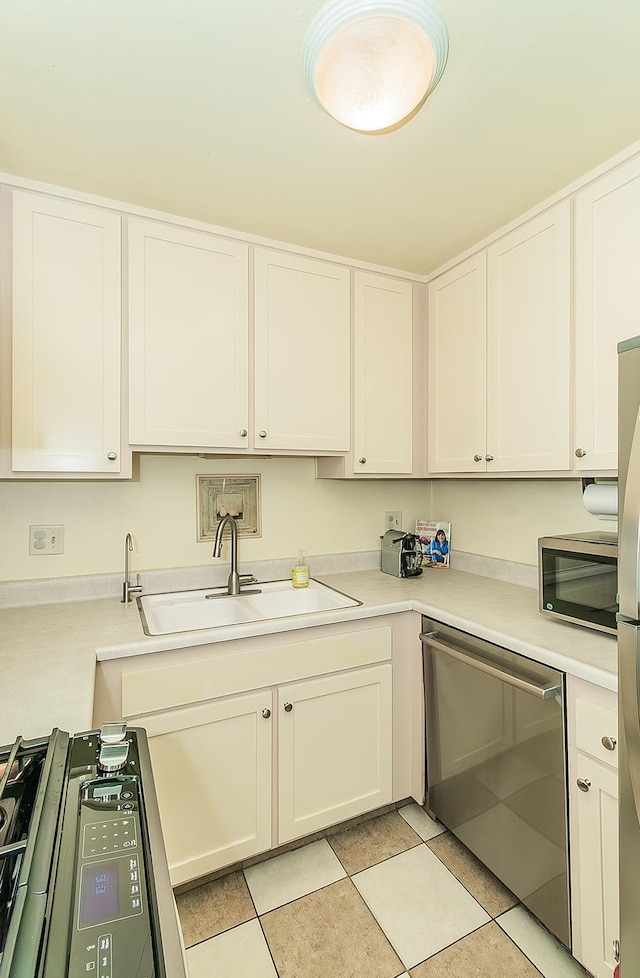 6338 N Maroa Ave Unit 115, Fresno, CA 93704 - kitchen with appliances with stainless steel finishes, light countertops, and white cabinetry