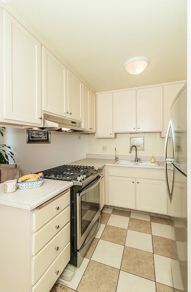 6338 N Maroa Ave Unit 115, Fresno, CA 93704 - kitchen featuring stainless steel appliances, under cabinet range hood, light countertops, and white cabinetry