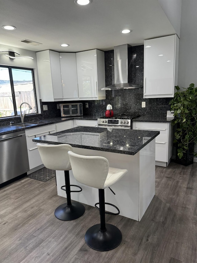 1723 Locust Ave, Clovis, CA 93611 - kitchen with wall chimney range hood, appliances with stainless steel finishes, modern cabinets, white cabinetry, and recessed lighting