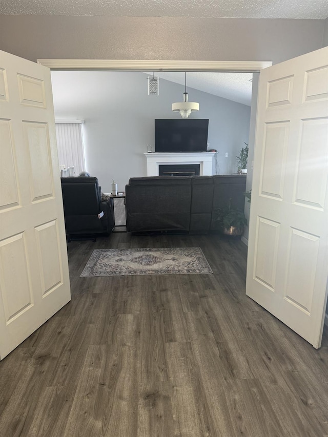 1723 Locust Ave, Clovis, CA 93611 - living room featuring dark wood finished floors, vaulted ceiling, and a fireplace