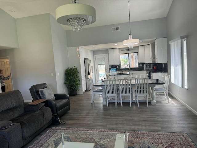 1723 Locust Ave, Clovis, CA 93611 - dining space featuring dark wood-type flooring and a chandelier