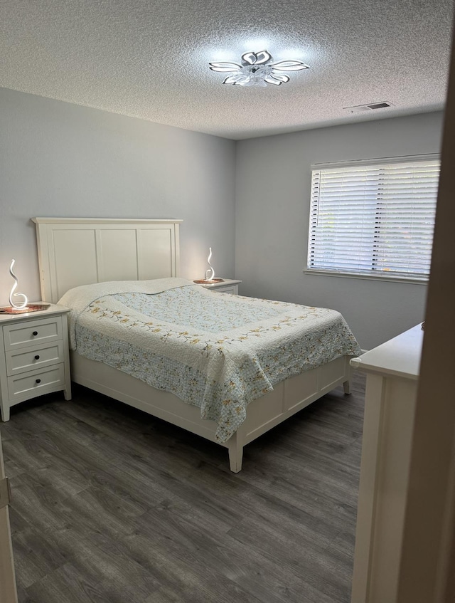 1723 Locust Ave, Clovis, CA 93611 - bedroom with a textured ceiling and dark wood-style flooring