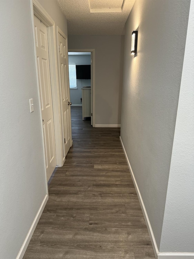 1723 Locust Ave, Clovis, CA 93611 - corridor featuring dark wood finished floors, a textured ceiling, and attic access