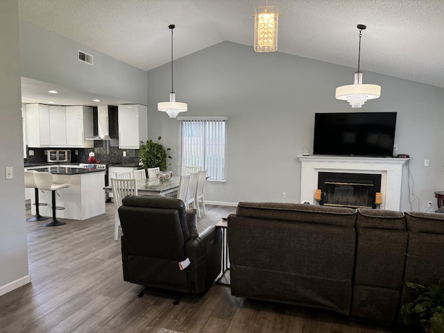 1723 Locust Ave, Clovis, CA 93611 - living room with dark wood-type flooring, a glass covered fireplace, and high vaulted ceiling