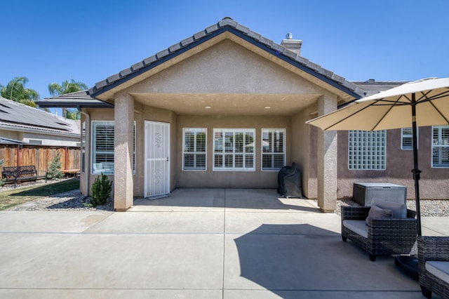 4994 W Minarets Ave, Fresno, CA 93722 - rear view of house with stucco siding and a patio