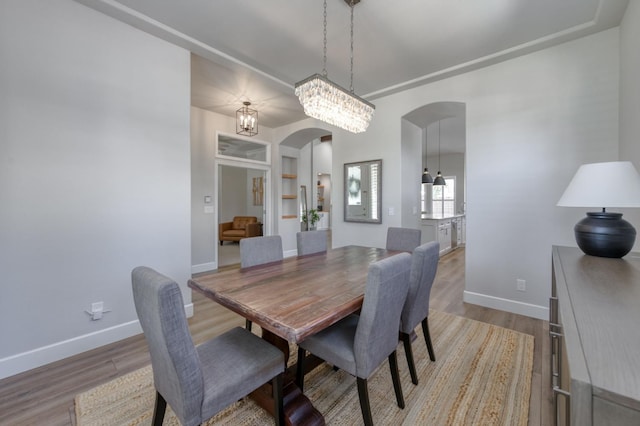 4994 W Minarets Ave, Fresno, CA 93722 - dining room featuring arched walkways, wood finished floors, and built in features