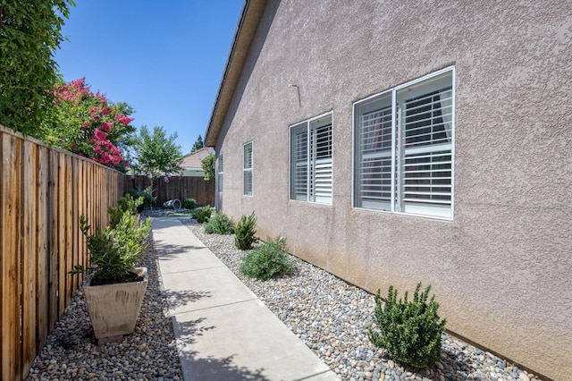 4994 W Minarets Ave, Fresno, CA 93722 - view of side of property with stucco siding and a fenced backyard