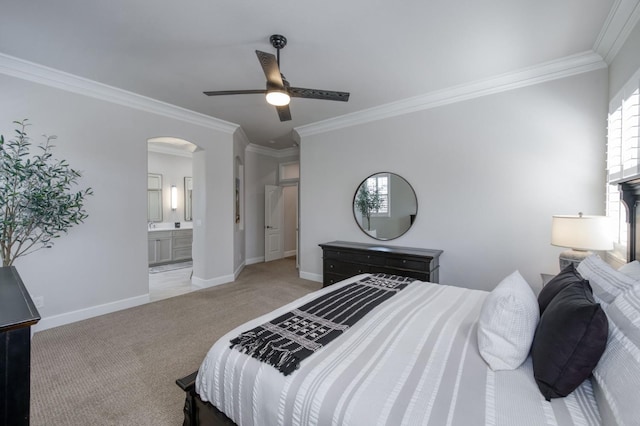 4994 W Minarets Ave, Fresno, CA 93722 - carpeted bedroom featuring arched walkways, crown molding, multiple windows, ensuite bath, and ceiling fan