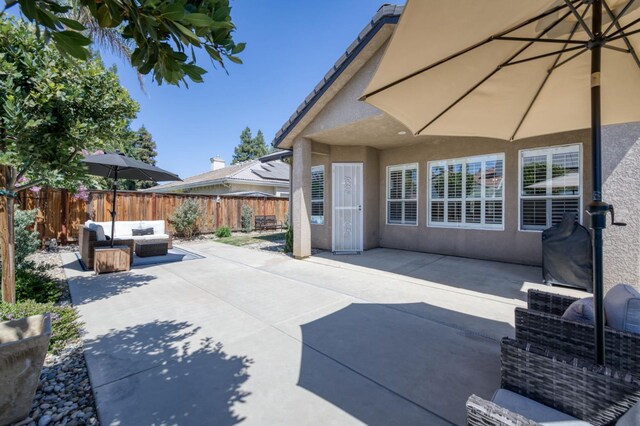 4994 W Minarets Ave, Fresno, CA 93722 - fenced backyard featuring an outdoor hangout area and a patio area