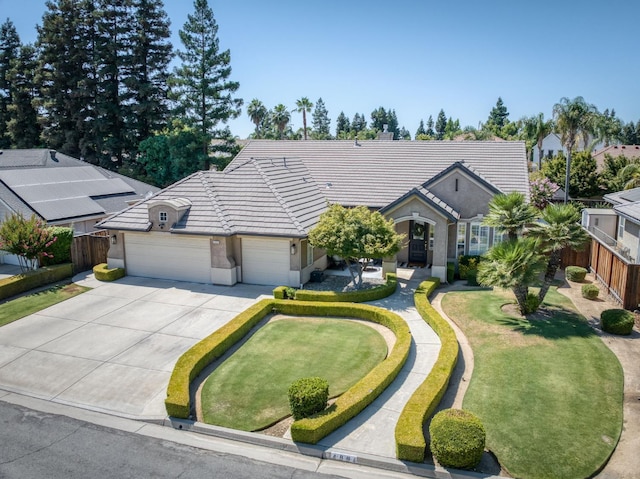 4994 W Minarets Ave, Fresno, CA 93722 - single story home with a tiled roof, an attached garage, driveway, and stucco siding