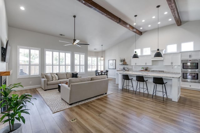 4994 W Minarets Ave, Fresno, CA 93722 - living room featuring beamed ceiling, high vaulted ceiling, a ceiling fan, wood finished floors, and recessed lighting