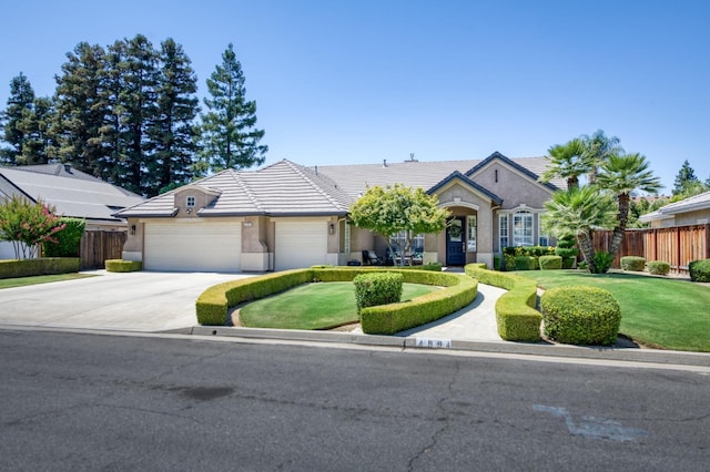 4994 W Minarets Ave, Fresno, CA 93722 - view of front of home featuring concrete driveway, an attached garage, a tiled roof, and stucco siding