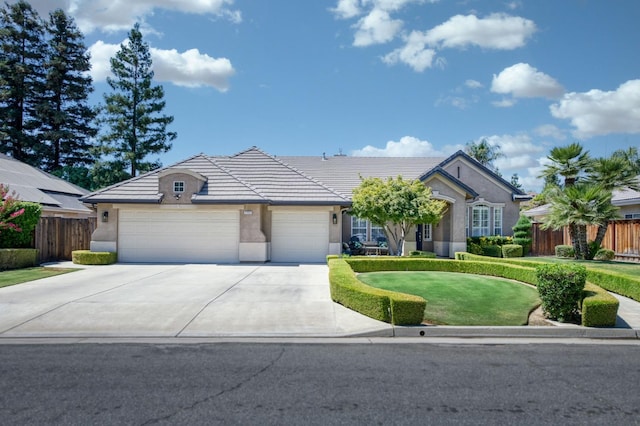 4994 W Minarets Ave, Fresno, CA 93722 - ranch-style house with stucco siding, an attached garage, concrete driveway, and a tiled roof