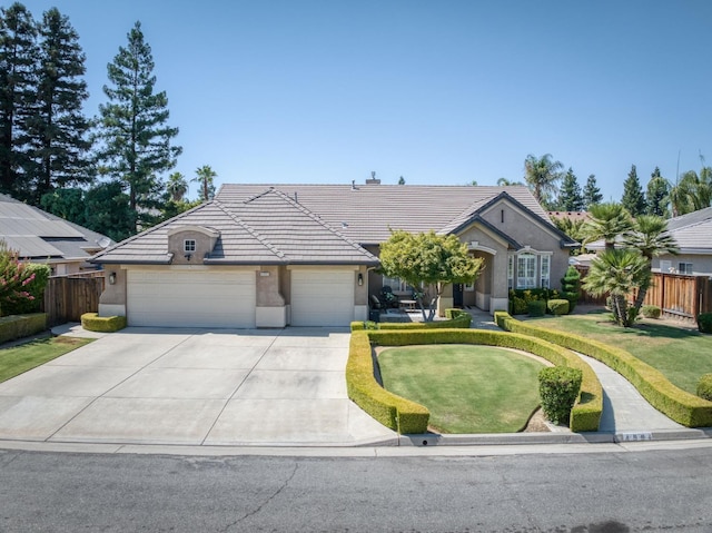 4994 W Minarets Ave, Fresno, CA 93722 - ranch-style house with a tiled roof, a garage, stucco siding, and driveway
