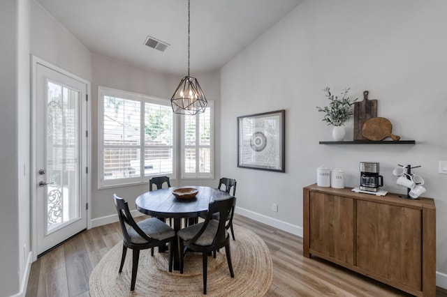 4994 W Minarets Ave, Fresno, CA 93722 - dining room featuring a chandelier and light wood-style flooring