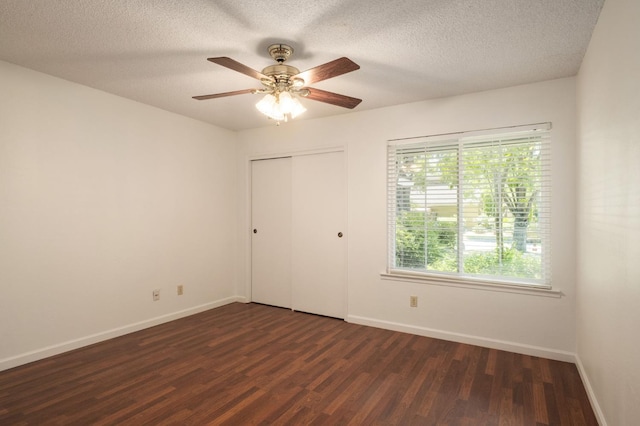 8298 N Calaveras St, Fresno, CA 93711 - unfurnished bedroom with dark wood-style floors, a textured ceiling, a closet, and a ceiling fan