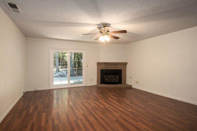 8298 N Calaveras St, Fresno, CA 93711 - unfurnished living room with dark wood-style flooring, a textured ceiling, a ceiling fan, and a brick fireplace