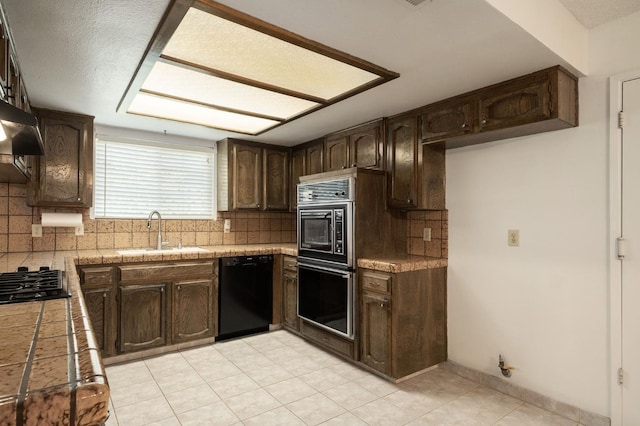 8298 N Calaveras St, Fresno, CA 93711 - kitchen with black appliances, dark brown cabinetry, backsplash, light tile patterned flooring, and extractor fan