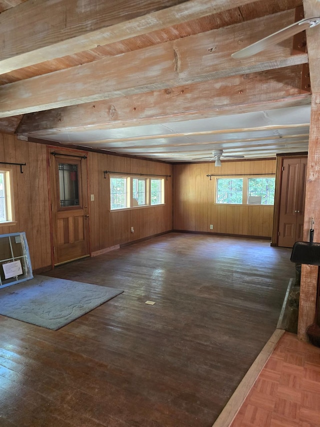 83703 Hazel, Wilsonia, CA 93633 - unfurnished living room featuring beamed ceiling, wooden walls, wood finished floors, and heating unit