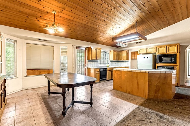 1401 S Villa Ave, Fresno, CA 93727 - kitchen featuring black appliances, tile counters, light tile patterned floors, a center island, and wood ceiling