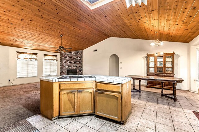 1401 S Villa Ave, Fresno, CA 93727 - kitchen featuring tile countertops, a ceiling fan, vaulted ceiling, arched walkways, and light tile patterned floors