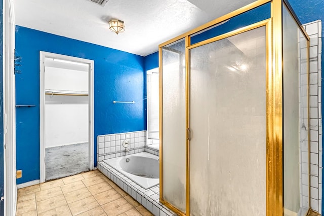 1401 S Villa Ave, Fresno, CA 93727 - bathroom featuring a stall shower, a bath, a walk in closet, and tile patterned floors