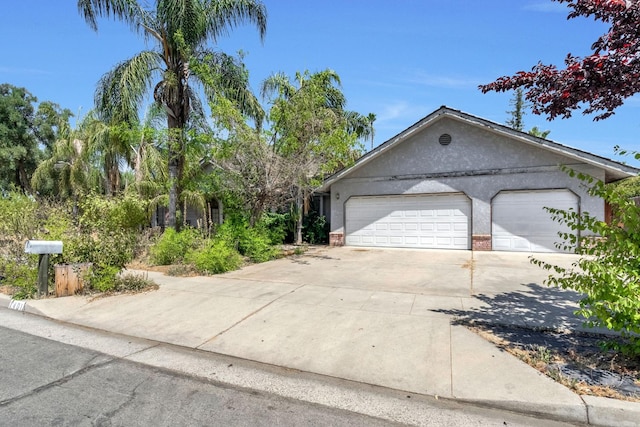 1401 S Villa Ave, Fresno, CA 93727 - view of front facade featuring driveway, brick siding, and stucco siding