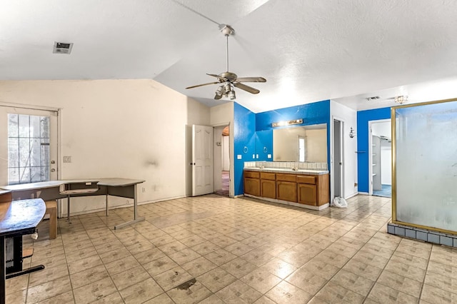 1401 S Villa Ave, Fresno, CA 93727 - kitchen with lofted ceiling, brown cabinets, a ceiling fan, and light countertops