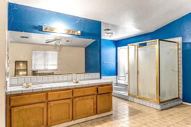 1401 S Villa Ave, Fresno, CA 93727 - full bathroom with a textured wall, a textured ceiling, a stall shower, double vanity, and a ceiling fan