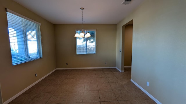 452 Rancho Mirage Rd, Madera, CA 93638 - empty room featuring healthy amount of natural light, tile patterned flooring, and a chandelier